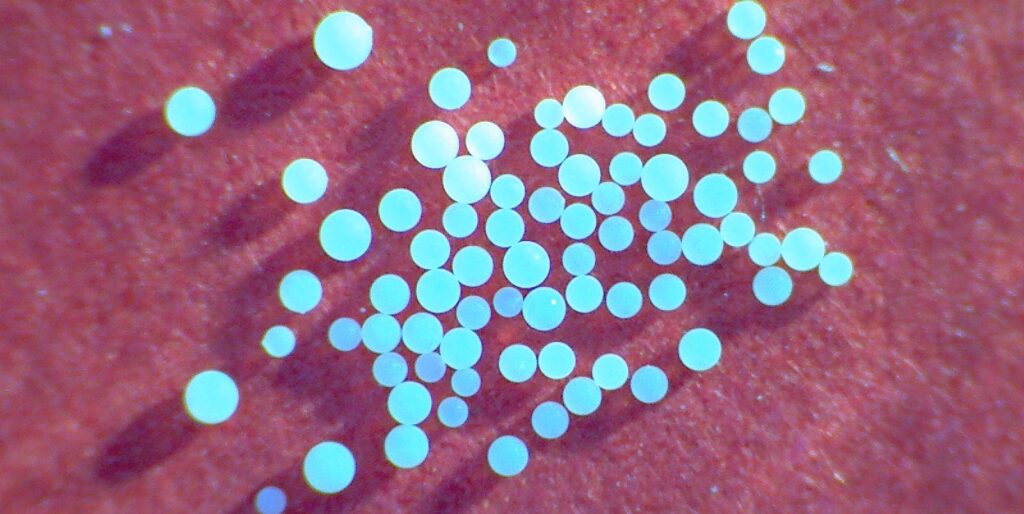 White opaque resins on a red background